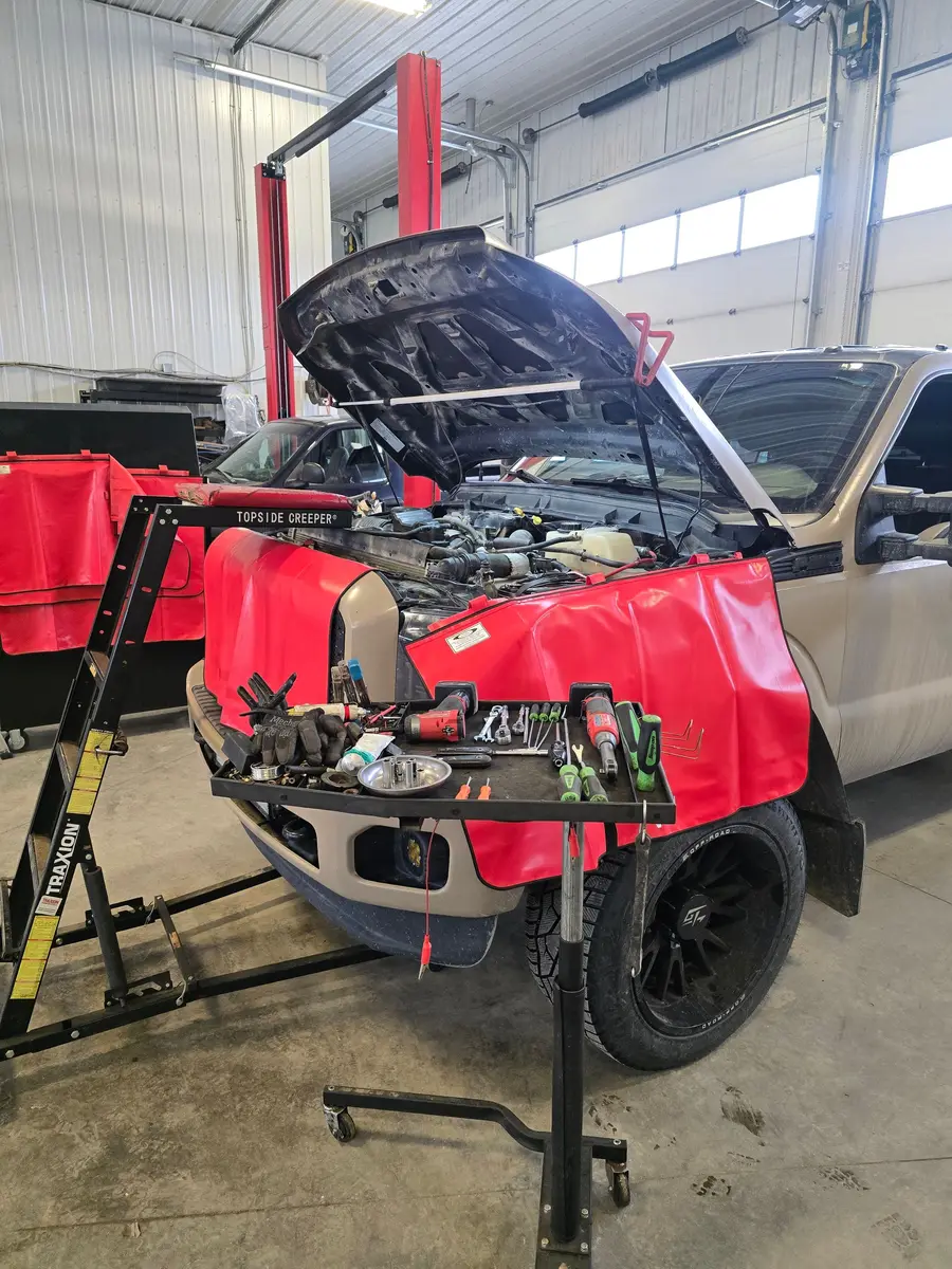 Truck with the hood open and fender covers on, ready for inspection
